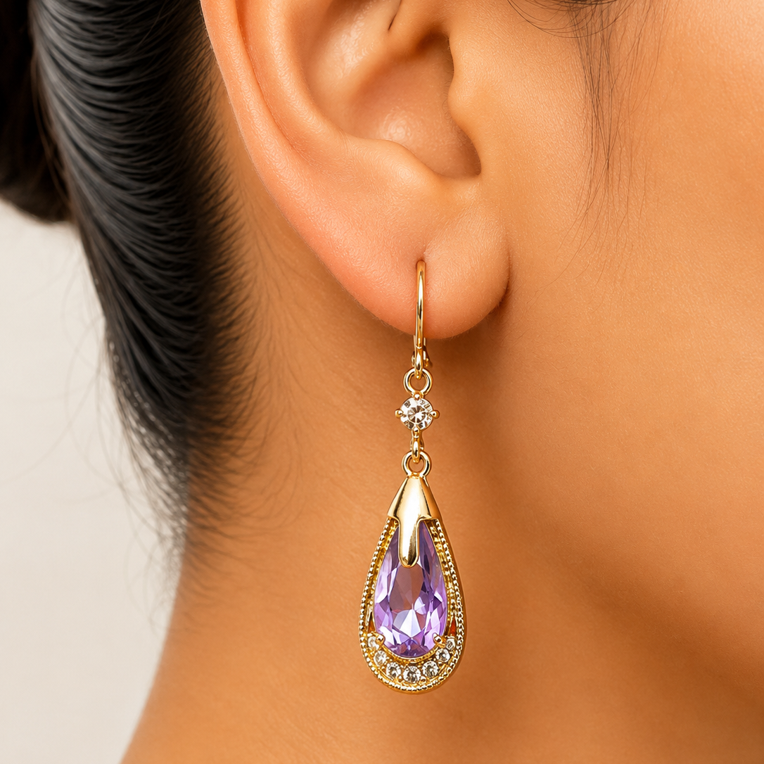 Teardrop-shaped earring with purple gemstone worn by a person