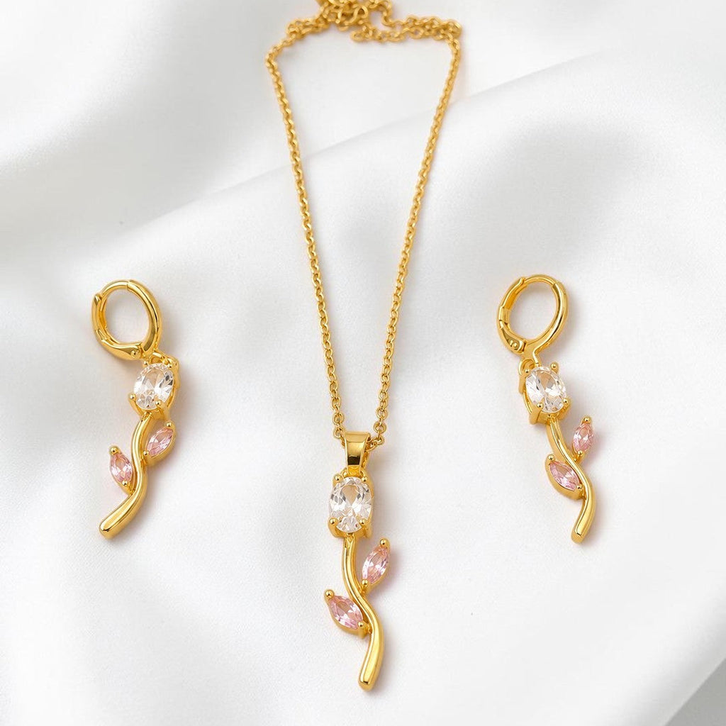 Gold  tone necklace and earrings set on a white background