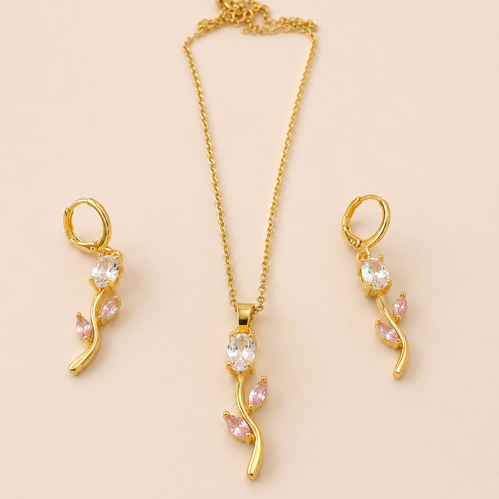 Gold  tone jewelry set with necklace and earrings on a beige background