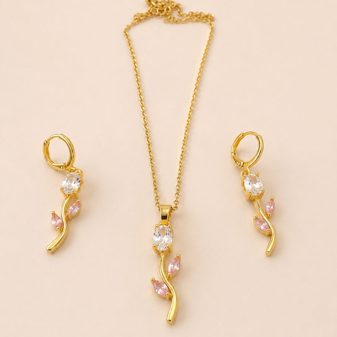 Gold  tone jewelry set with necklace and earrings on a beige background