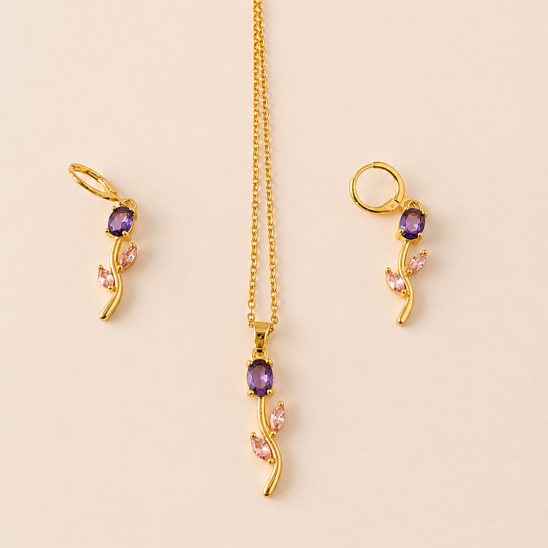 Gold  tone necklace with purple and pink gemstones on a beige background