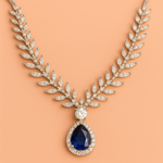 Elegant necklace with a blue gemstone and american diamond accents on a peach background