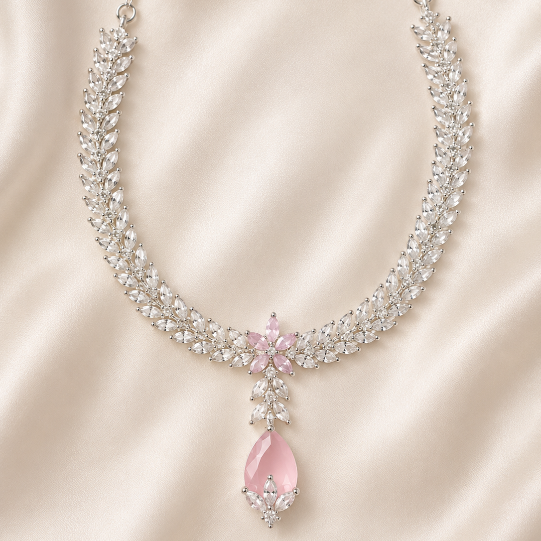 Elegant necklace with pink teardrop pendant on a satin background