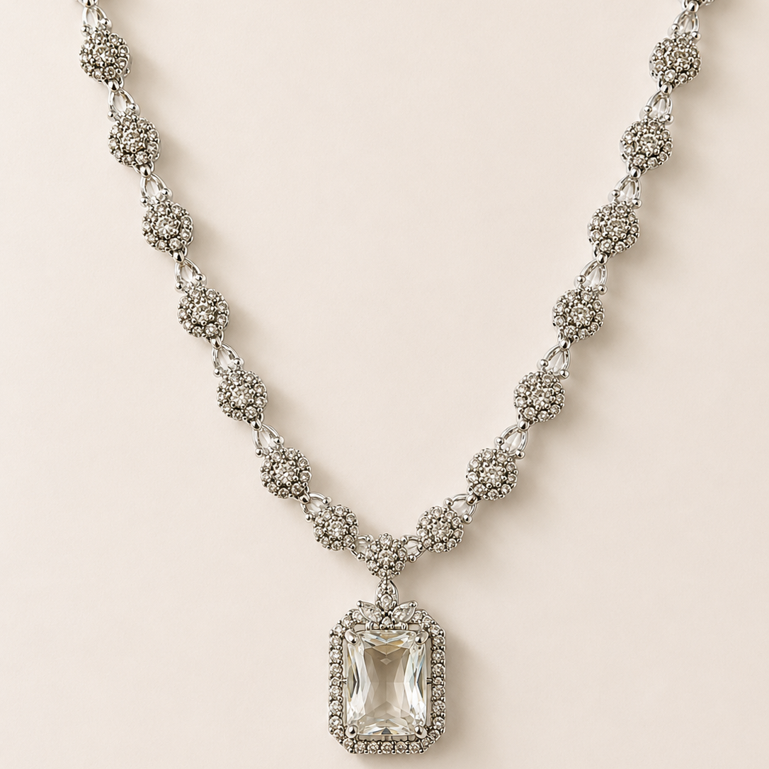 Elegant necklace with a clear pendant on a light beige background