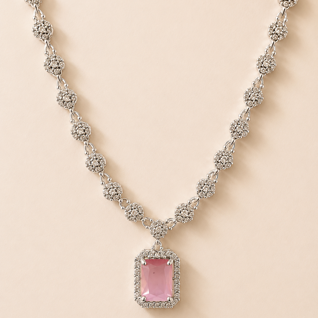 Necklace with a pink gemstone pendant on a beige background
