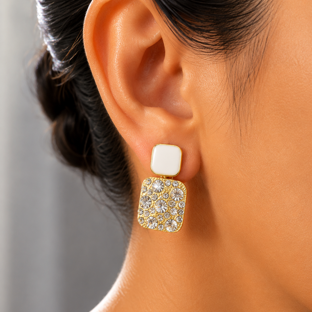 Close-up of a person wearing a gold and diamond earring.