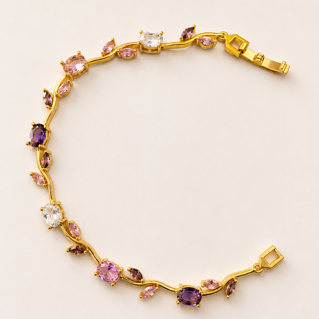 Gold tone bracelet with multicolored gemstones on a light beige background