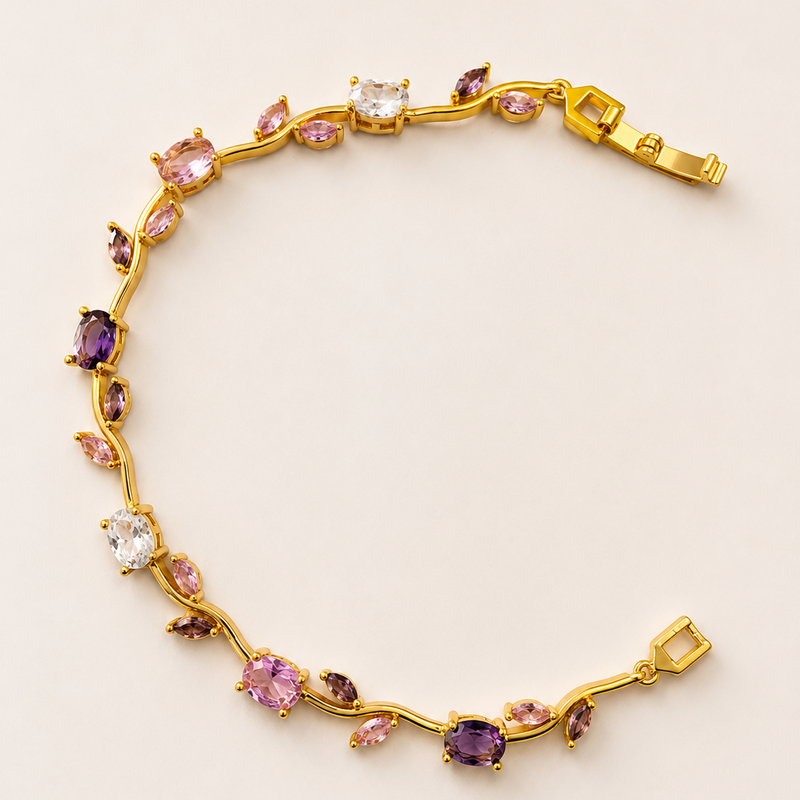 Gold tone bracelet with multicolored gemstones on a light beige background