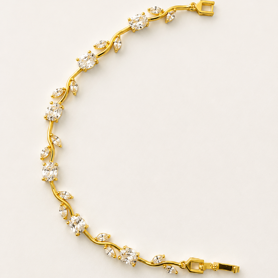 Gold tone bracelet with floral design on a light beige background