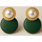 Pair of earrings with gold tone circular designs and green round bases on a beige background