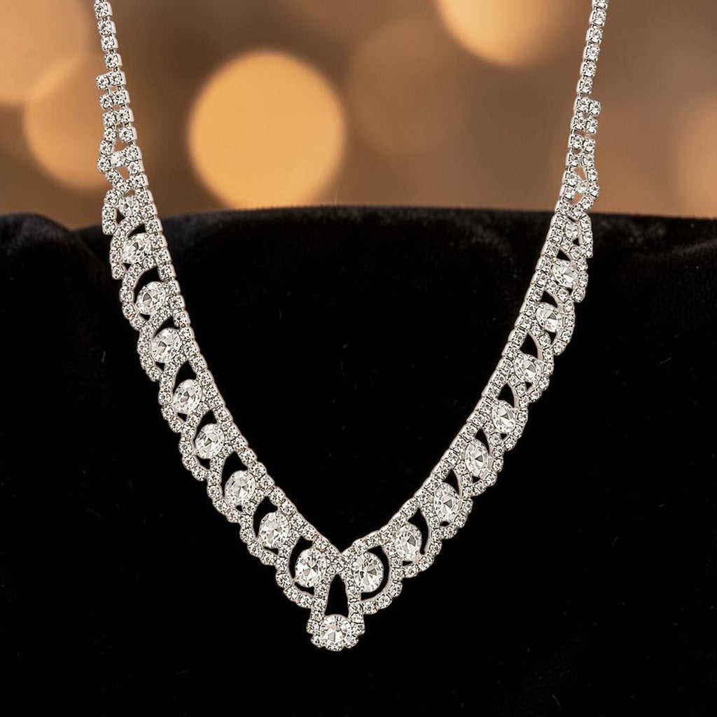 Elegant american diamond necklace on a black cushion with a blurred golden background