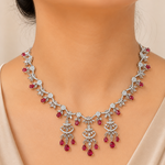 Delicate necklace with red gemstones on a mannequin