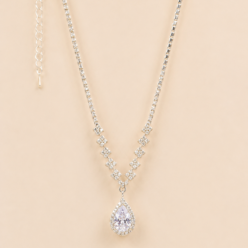 Teardrop american diamond pendant necklace on a beige background