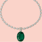 Diamond necklace with a green gemstone pendant on a pink background