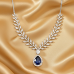 Elegant necklace with a blue gemstone on a gold satin background
