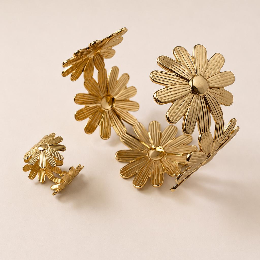Golden floral earrings on a beige background