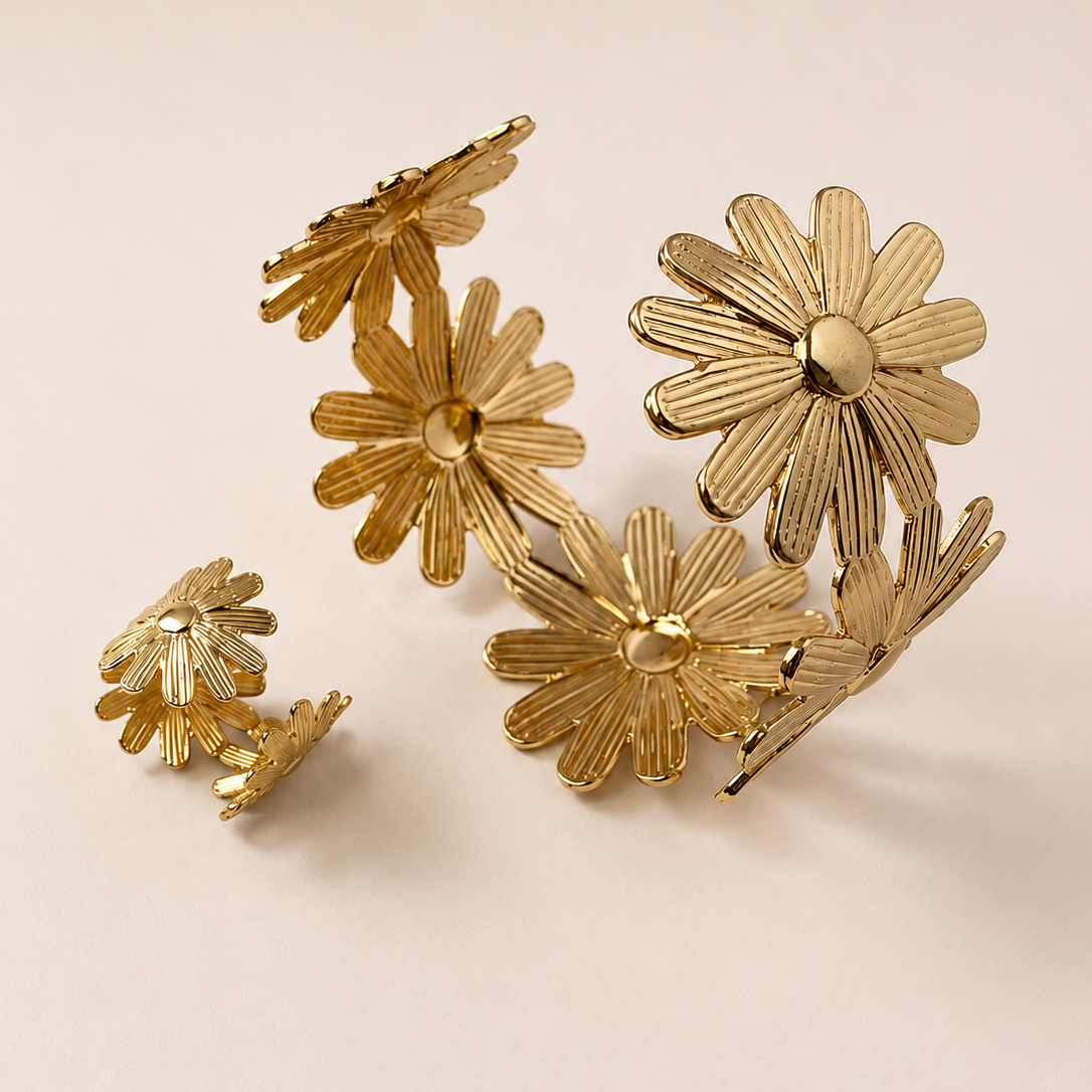 Golden floral earrings on a beige background