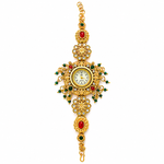 A gold-plated ornate wrist watch with a central round dial, decorated with red and green stones and intricate filigree details, shown on a plain white background.