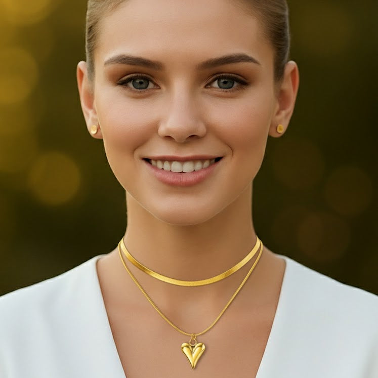 Woman wearing gold necklaces with a blurred golden background