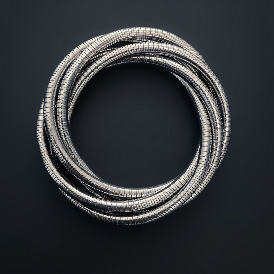 Coiled silver metal hose on a black background