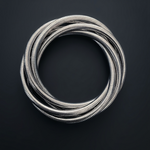 Coiled silver metal hose on a black background