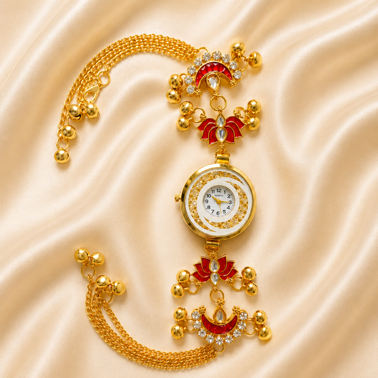 A gold-plated ornate wrist watch with red enamel floral details and crystal accents, displayed on a beige satin fabric background.