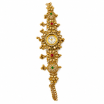An ornate gold-toned vintage-style watch with intricate filigree details, set with red and green gemstones and a white dial, shown on a plain white background.