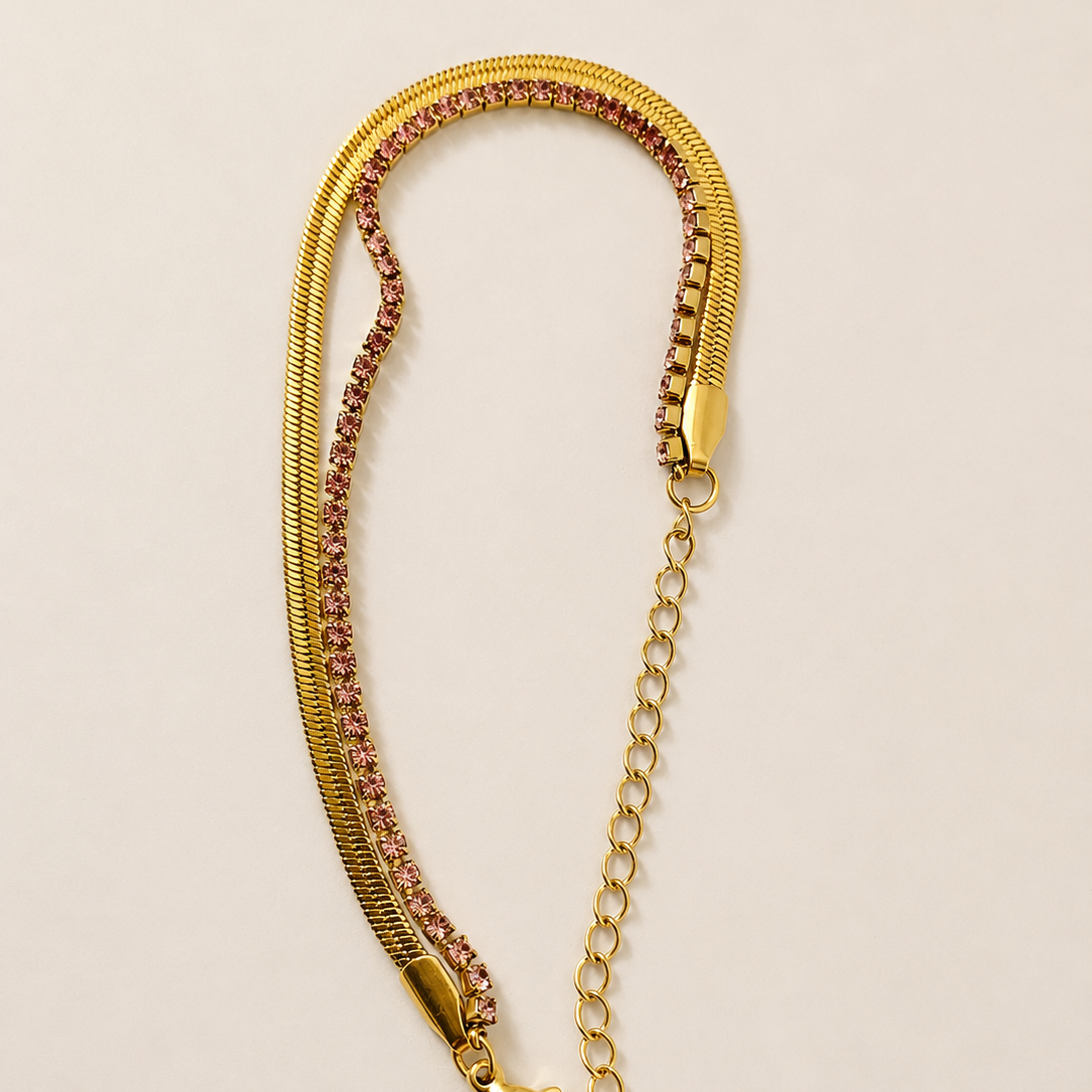 Gold tone chain with a clasp on a beige background