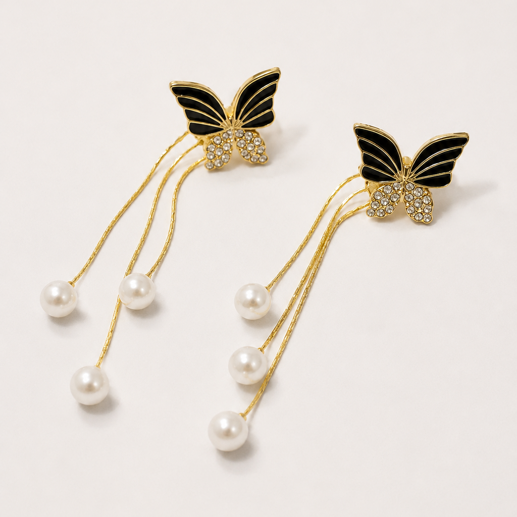 Butterfly earrings with pearl drops on a white background