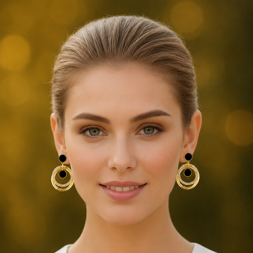 Woman wearing golden hoop earrings with black centers against a blurred background