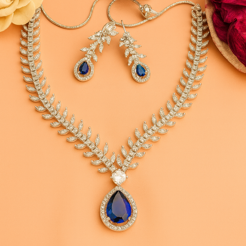 Jewelry set with necklace and earrings on a peach background