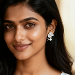 Close-up of a woman wearing floral earrings with a blurred background
