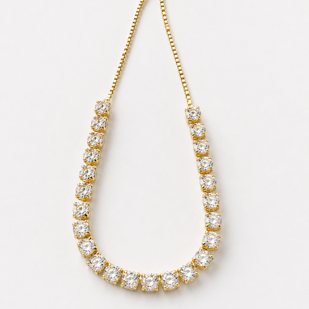 Gold tone bracelet with clear stones on a white background