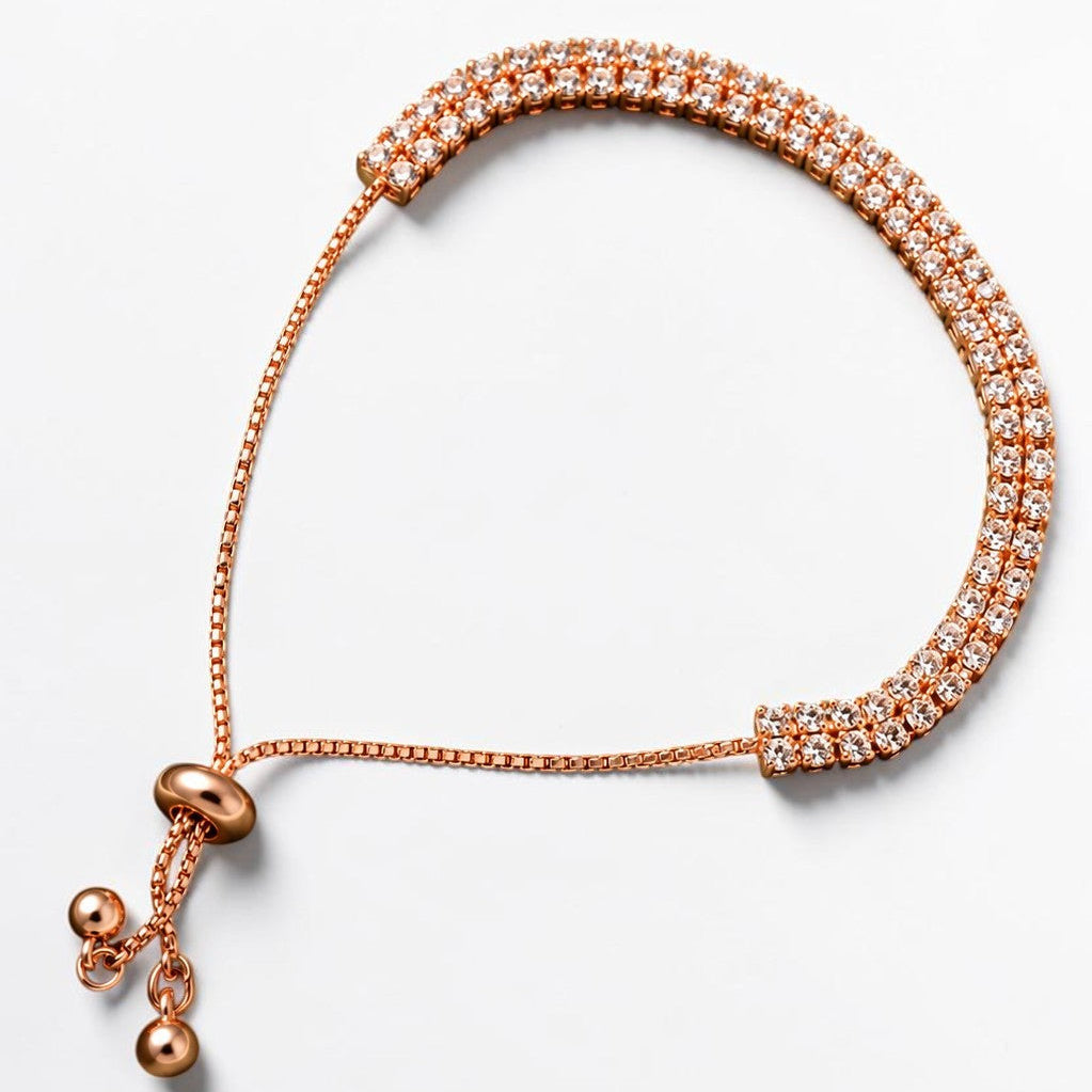 A rose gold adjustable cord bracelet with a textured woven band and a sliding bead closure, shown on a clean white background.