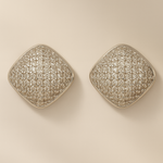 Pair of silver square earrings on a beige background