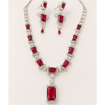 Jewelry set with necklace and earrings featuring red gemstones on a white background