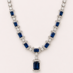 Elegant necklace with blue gemstones and diamonds on a white background