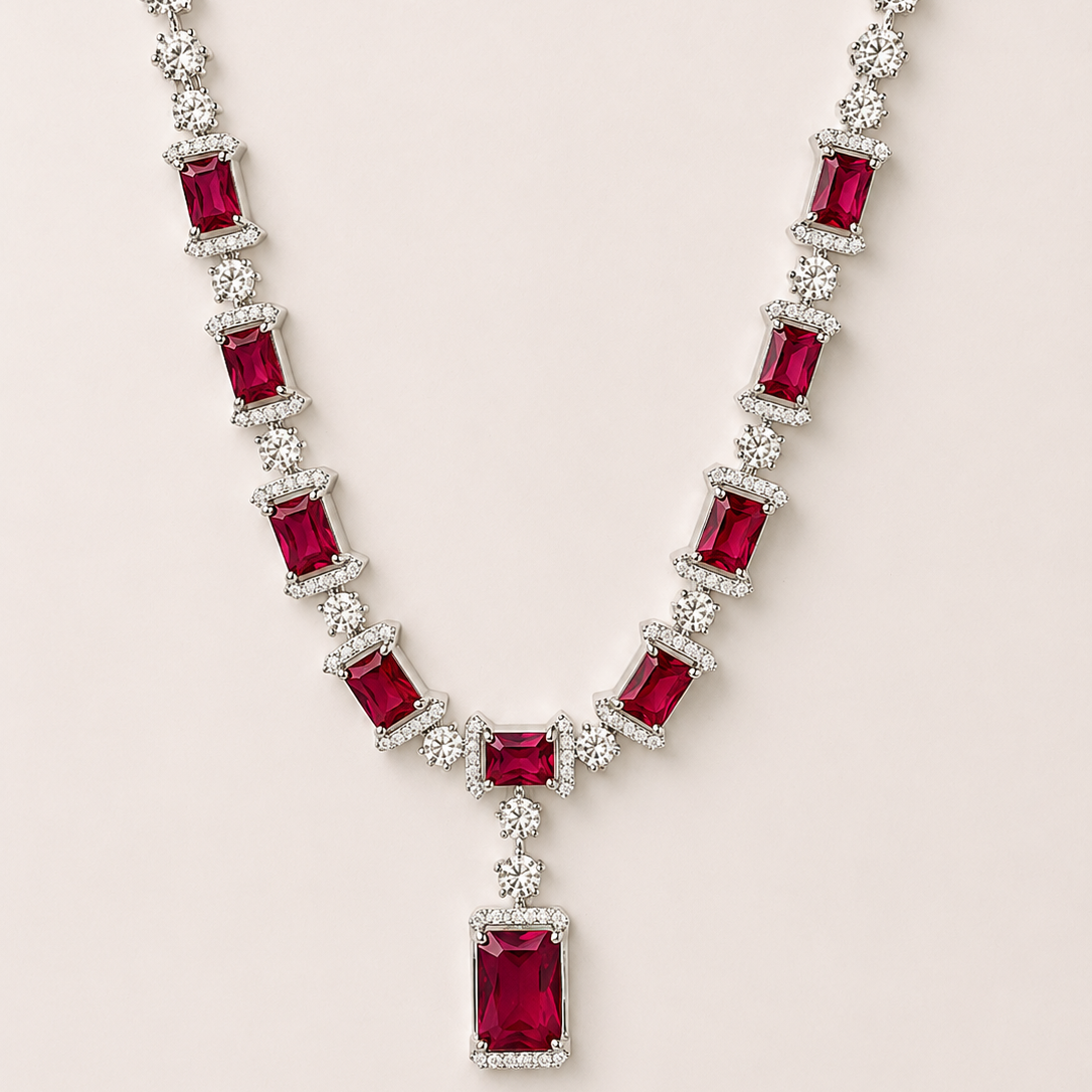 Necklace with red gemstones and clear stones on a light pink background