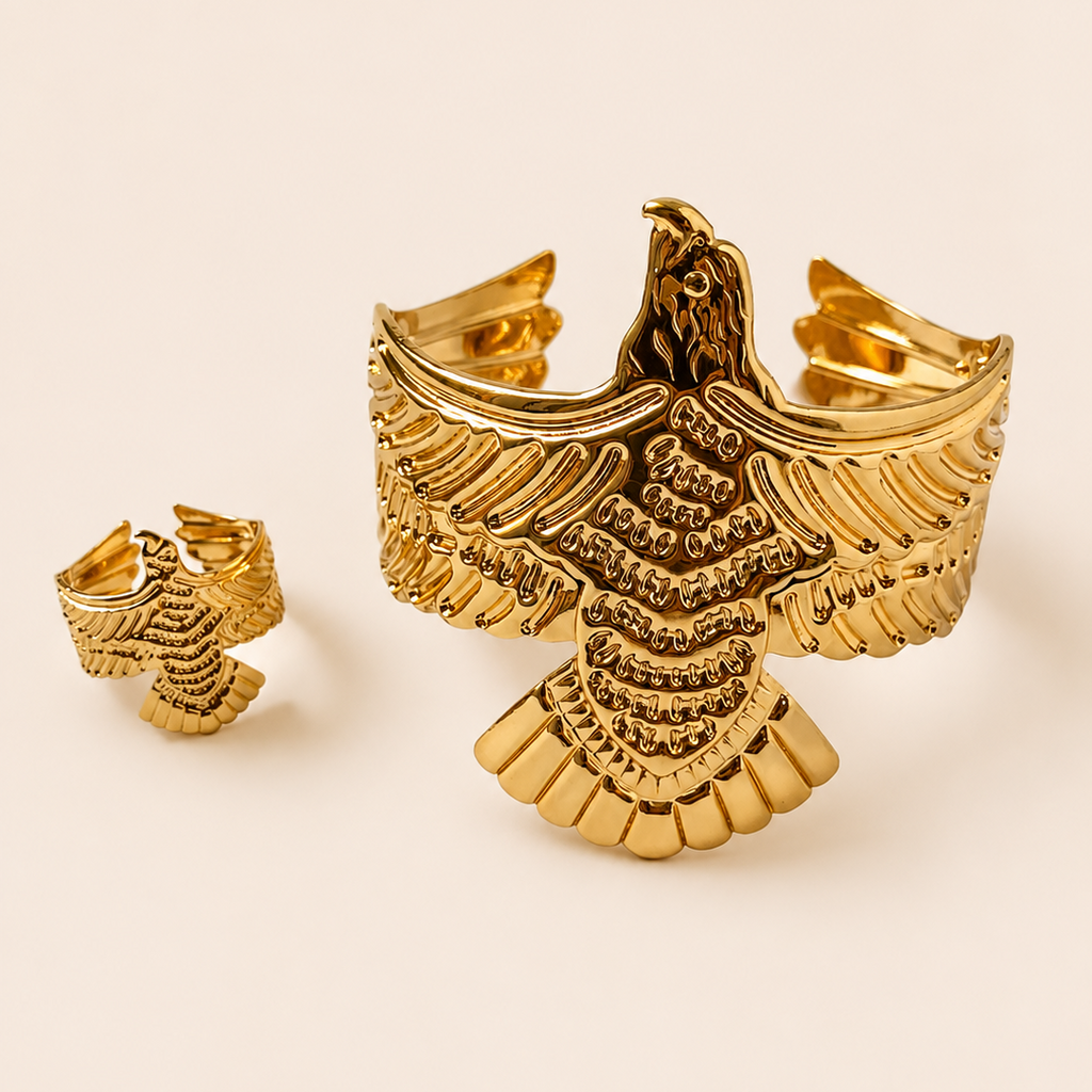 Gold tone eagle-shaped cufflinks on a beige background