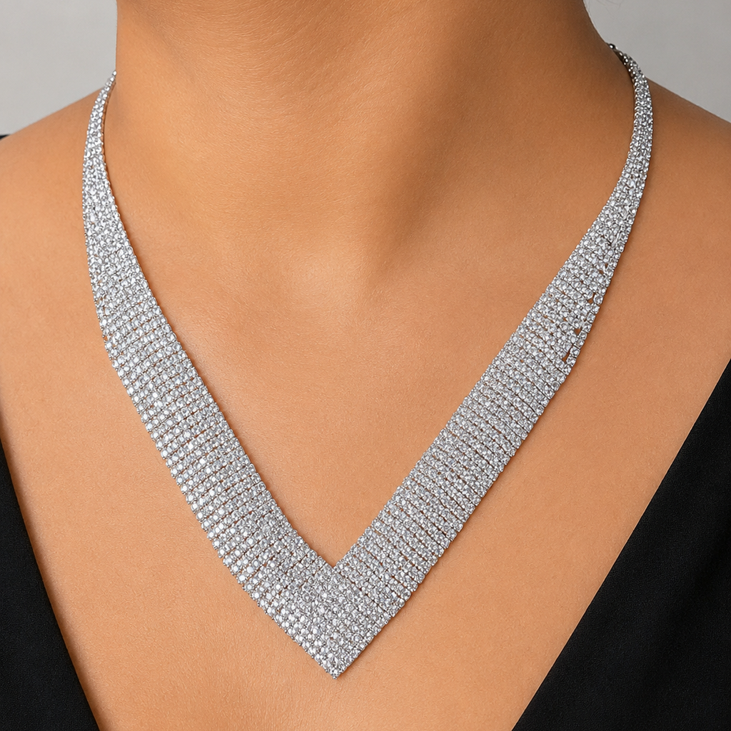 Silver necklace on a model against a neutral background